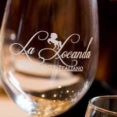 a La Locanda wine glass with frosted text
