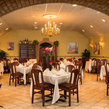 our main dining room with high ceilings and a chandelier